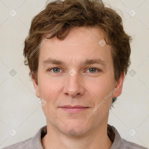 Joyful white adult male with short  brown hair and grey eyes