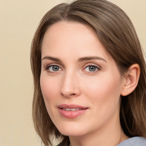 Joyful white young-adult female with medium  brown hair and grey eyes