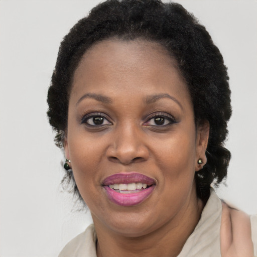 Joyful black adult female with short  brown hair and brown eyes