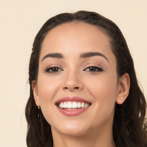 Joyful white young-adult female with long  black hair and brown eyes