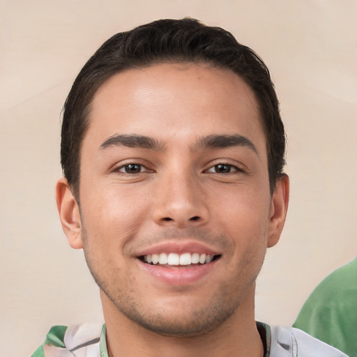 Joyful white young-adult male with short  brown hair and brown eyes