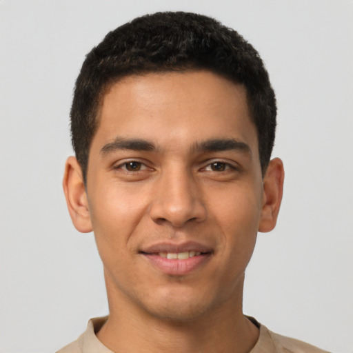 Joyful latino young-adult male with short  black hair and brown eyes