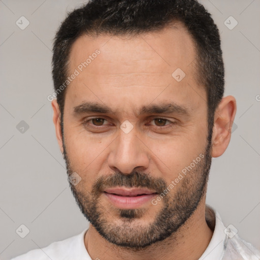 Joyful white adult male with short  black hair and brown eyes