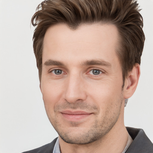 Joyful white adult male with short  brown hair and grey eyes