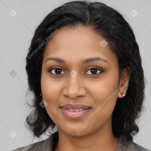 Joyful black young-adult female with long  black hair and brown eyes