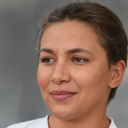 Joyful white adult female with short  brown hair and brown eyes