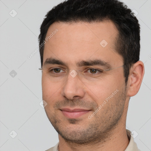 Joyful white young-adult male with short  black hair and brown eyes