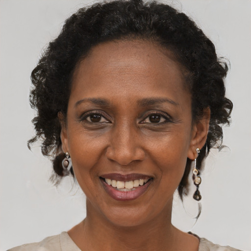 Joyful black adult female with short  brown hair and brown eyes