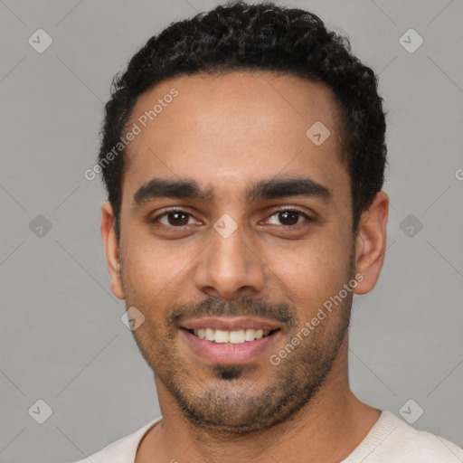 Joyful latino young-adult male with short  black hair and brown eyes