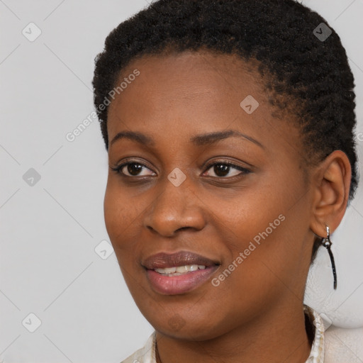 Joyful black young-adult female with short  brown hair and brown eyes