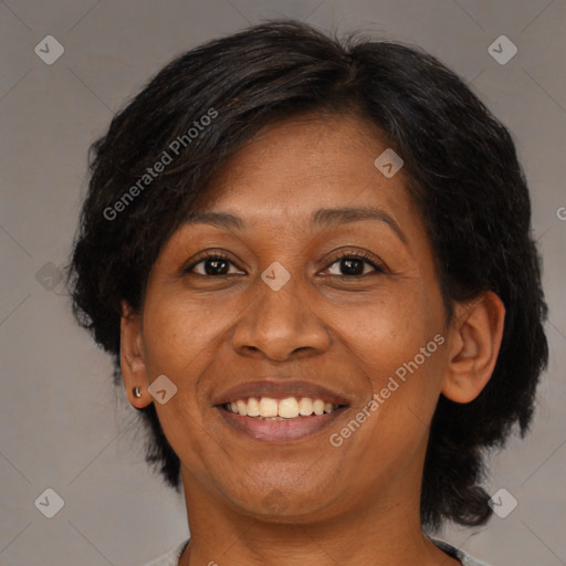 Joyful black adult female with medium  brown hair and brown eyes