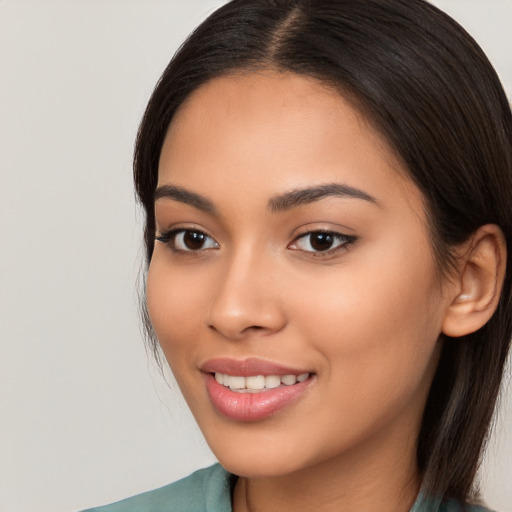 Joyful latino young-adult female with long  brown hair and brown eyes