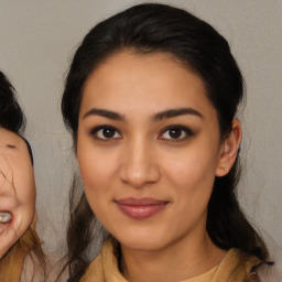 Joyful latino young-adult female with medium  brown hair and brown eyes