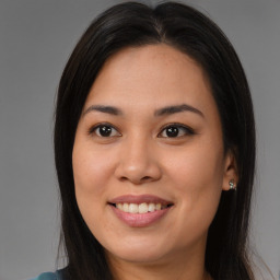 Joyful asian young-adult female with long  brown hair and brown eyes