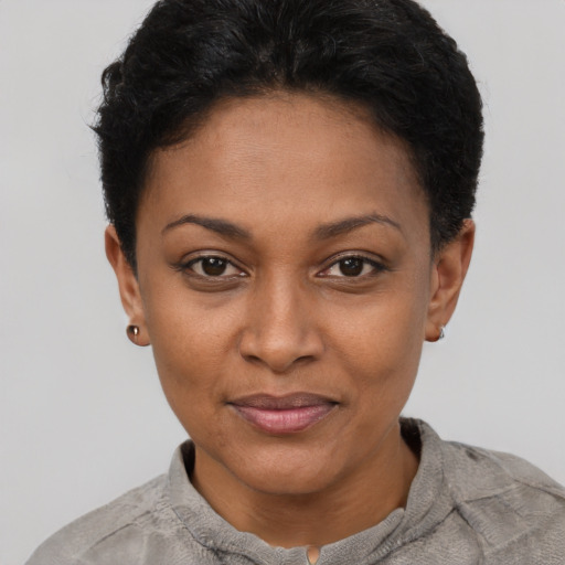 Joyful black young-adult female with short  black hair and brown eyes