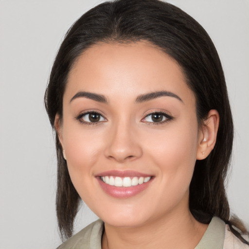 Joyful white young-adult female with medium  brown hair and brown eyes