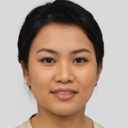 Joyful asian young-adult female with short  brown hair and brown eyes