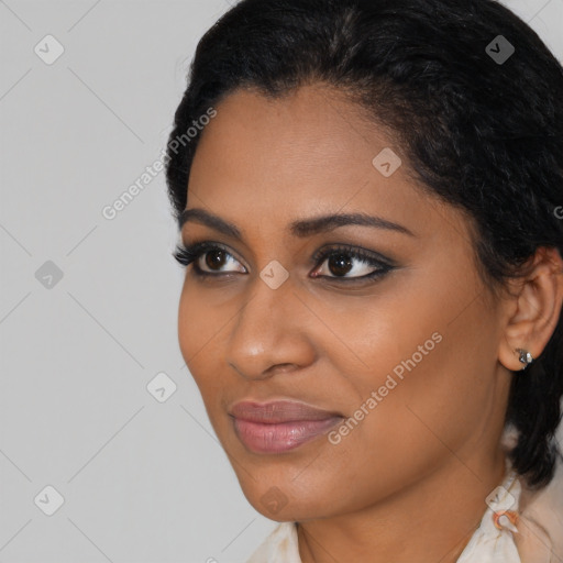 Joyful black young-adult female with medium  black hair and brown eyes