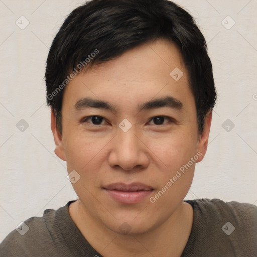 Joyful asian young-adult male with short  black hair and brown eyes