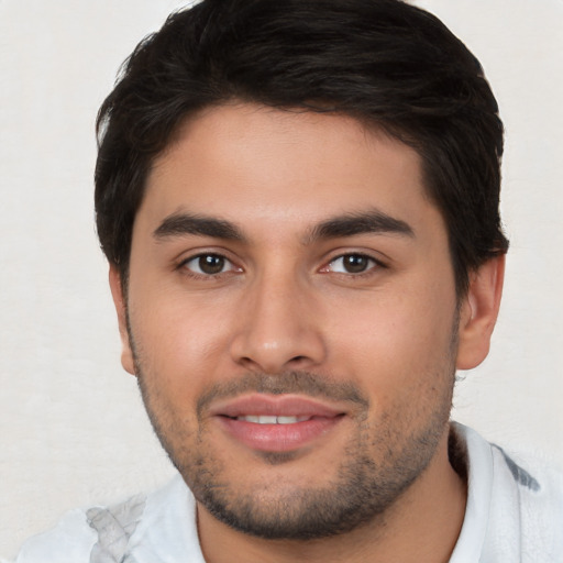 Joyful white young-adult male with short  brown hair and brown eyes