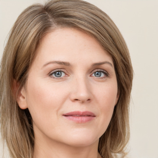 Joyful white young-adult female with long  brown hair and green eyes