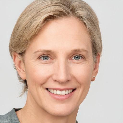 Joyful white adult female with medium  brown hair and grey eyes