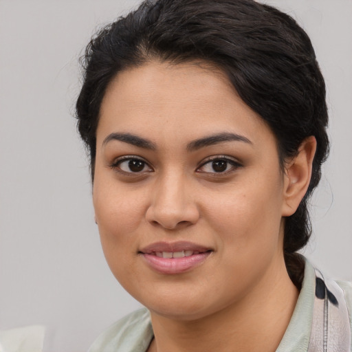 Joyful latino young-adult female with medium  brown hair and brown eyes