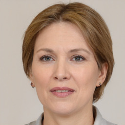 Joyful white adult female with medium  brown hair and grey eyes