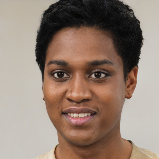 Joyful black young-adult female with short  black hair and brown eyes