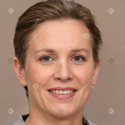 Joyful white adult female with medium  brown hair and grey eyes