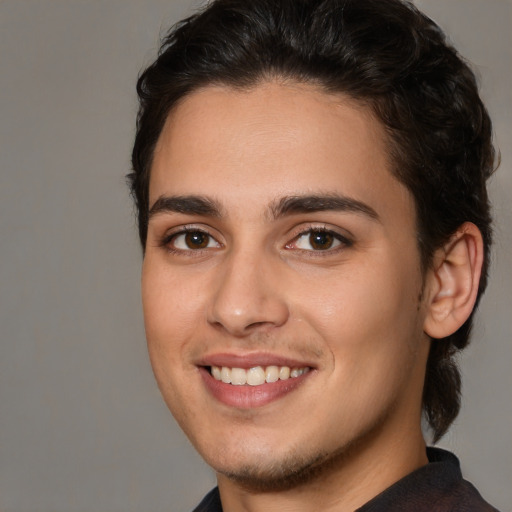 Joyful white young-adult male with medium  brown hair and brown eyes