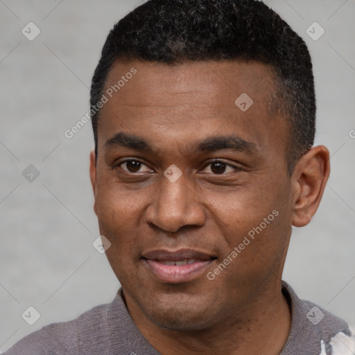 Joyful black young-adult male with short  black hair and brown eyes