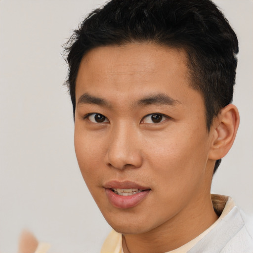 Joyful asian young-adult male with short  brown hair and brown eyes
