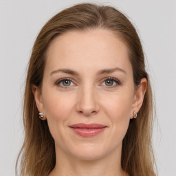 Joyful white young-adult female with long  brown hair and grey eyes