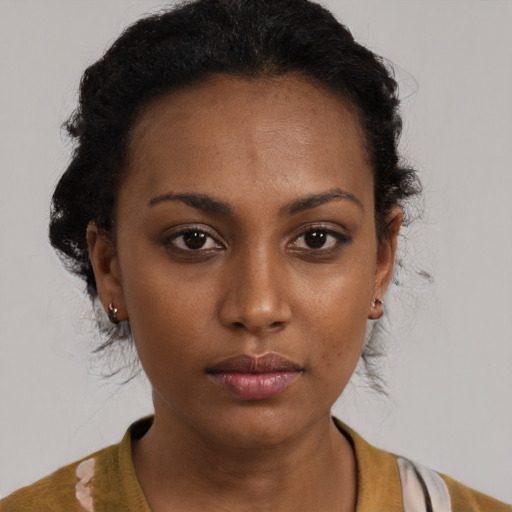Neutral black young-adult female with medium  brown hair and brown eyes