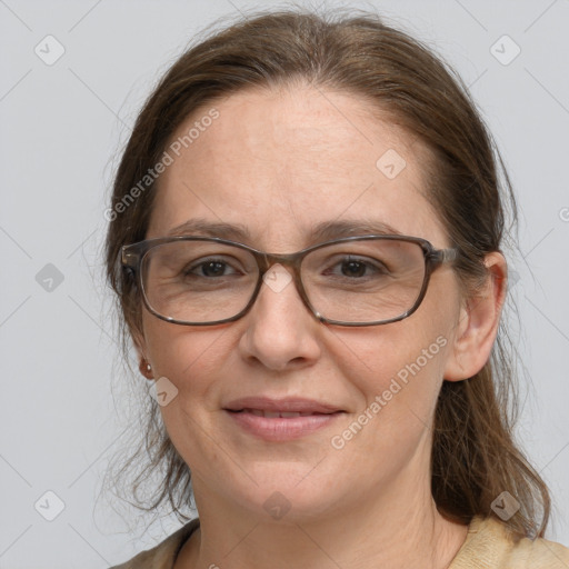 Joyful white adult female with medium  brown hair and grey eyes