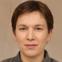 Joyful white adult male with short  brown hair and brown eyes