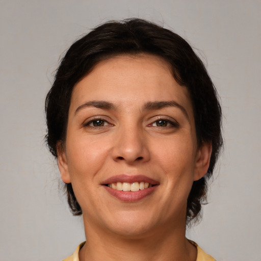 Joyful white young-adult female with medium  brown hair and brown eyes