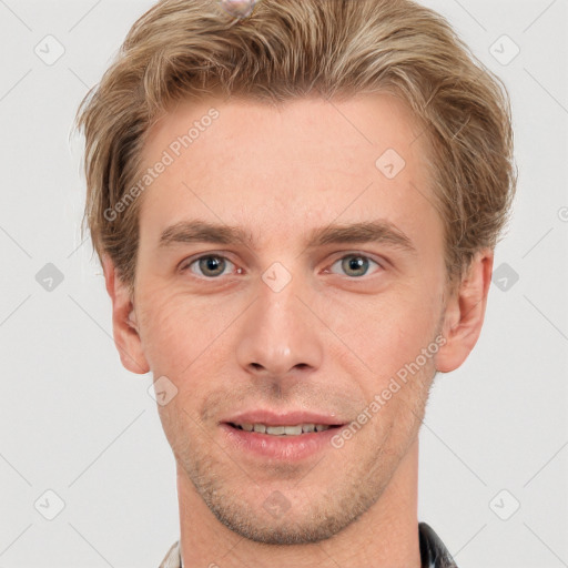 Joyful white young-adult male with short  brown hair and grey eyes