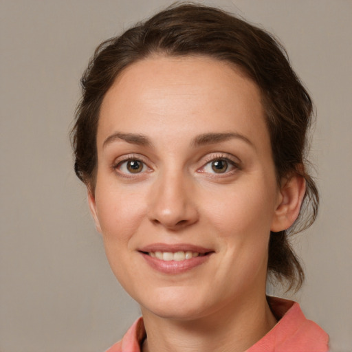 Joyful white young-adult female with medium  brown hair and grey eyes