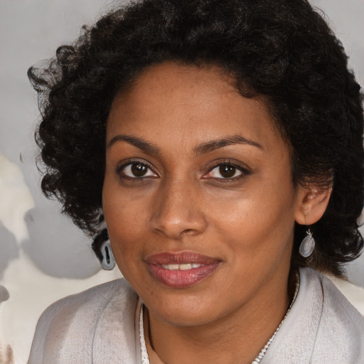 Joyful black young-adult female with medium  brown hair and brown eyes