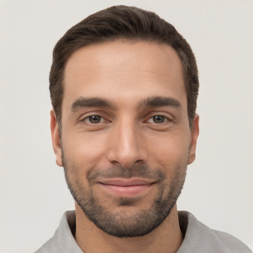 Joyful white young-adult male with short  brown hair and brown eyes