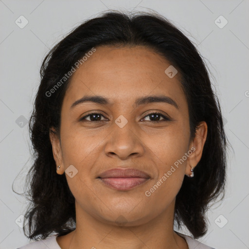 Joyful latino adult female with medium  brown hair and brown eyes