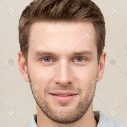 Joyful white young-adult male with short  brown hair and grey eyes