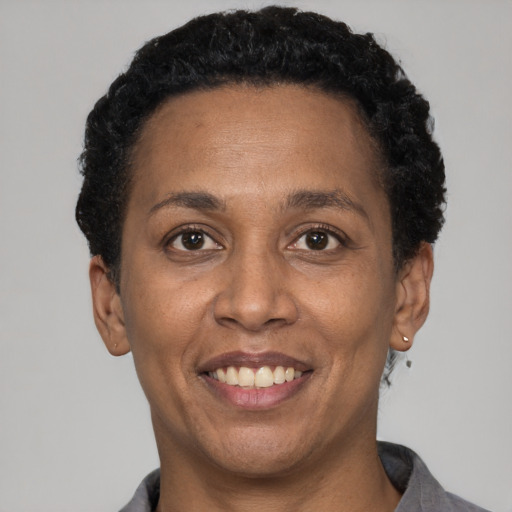 Joyful latino adult female with short  black hair and brown eyes