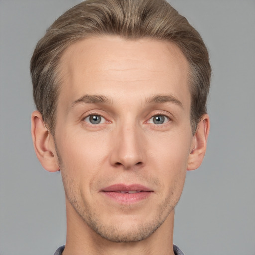 Joyful white adult male with short  brown hair and grey eyes