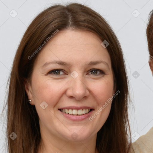 Joyful white adult female with long  brown hair and brown eyes