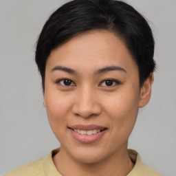 Joyful asian young-adult female with short  brown hair and brown eyes