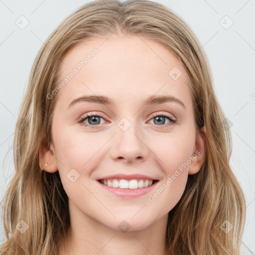 Joyful white young-adult female with long  brown hair and blue eyes