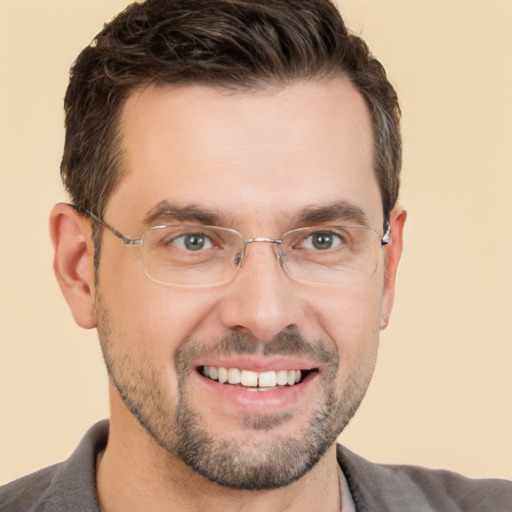 Joyful white adult male with short  brown hair and brown eyes